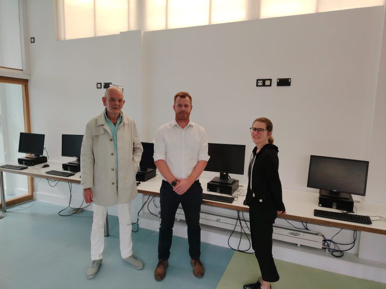 Gary from Hackney Marsh Partnership, Dean from Aston Group and Sarah from Hackney Giving in front of donated computers